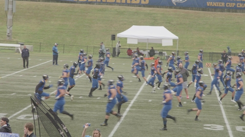 Thumbnail for Wide Shot of Football Players warming up on the field