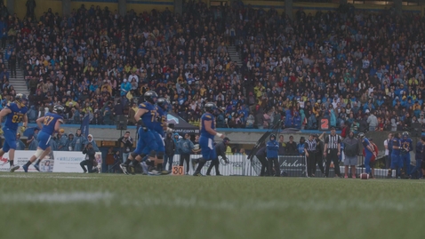 Thumbnail for Homecoming Gameplay 3: Wide shot of Football Players forming at line of scrimmage